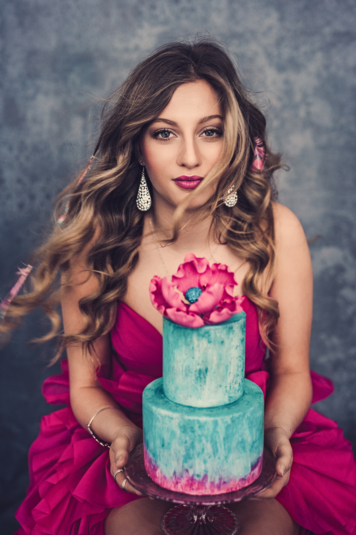 Beautiful young woman with pretty cake in pink